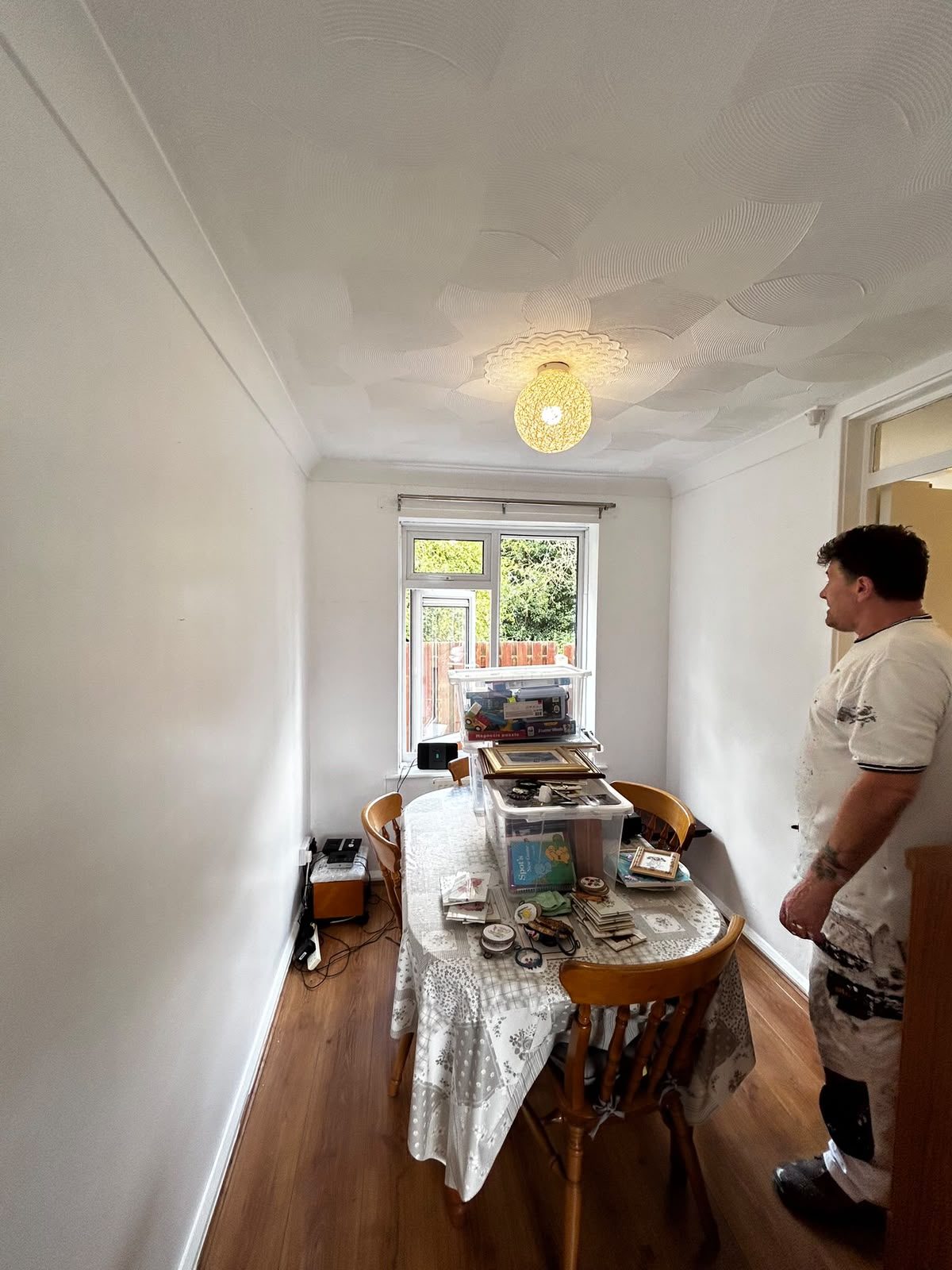 Dining room being decorated with furniture covered