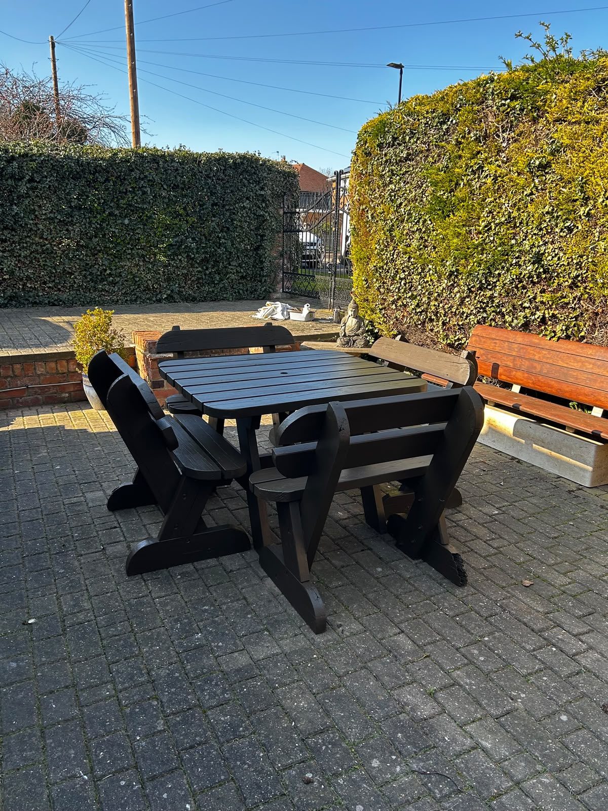 Garden table and benches repainted in dark grey on a patio