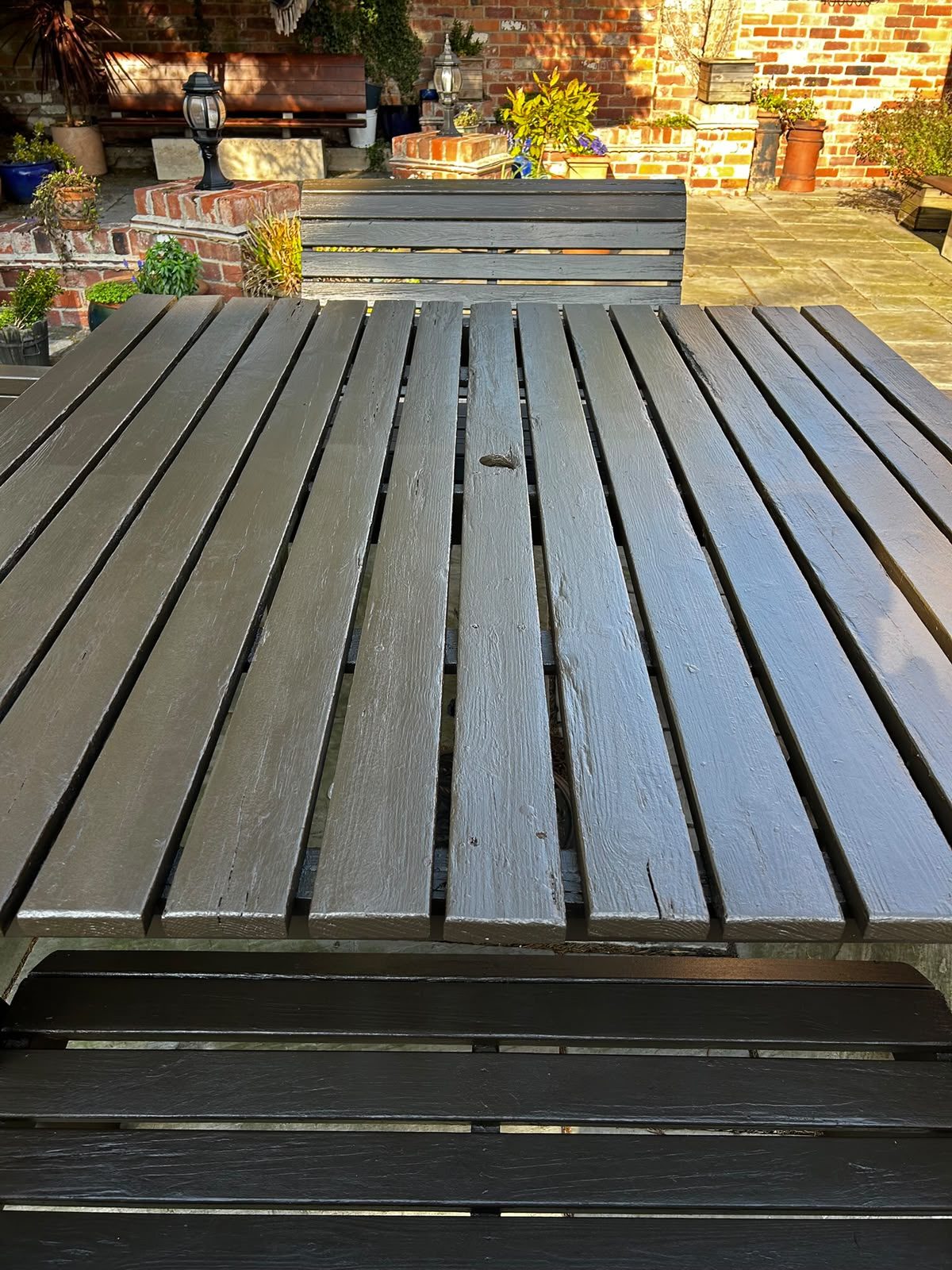 Close-up of a freshly painted slatted garden table