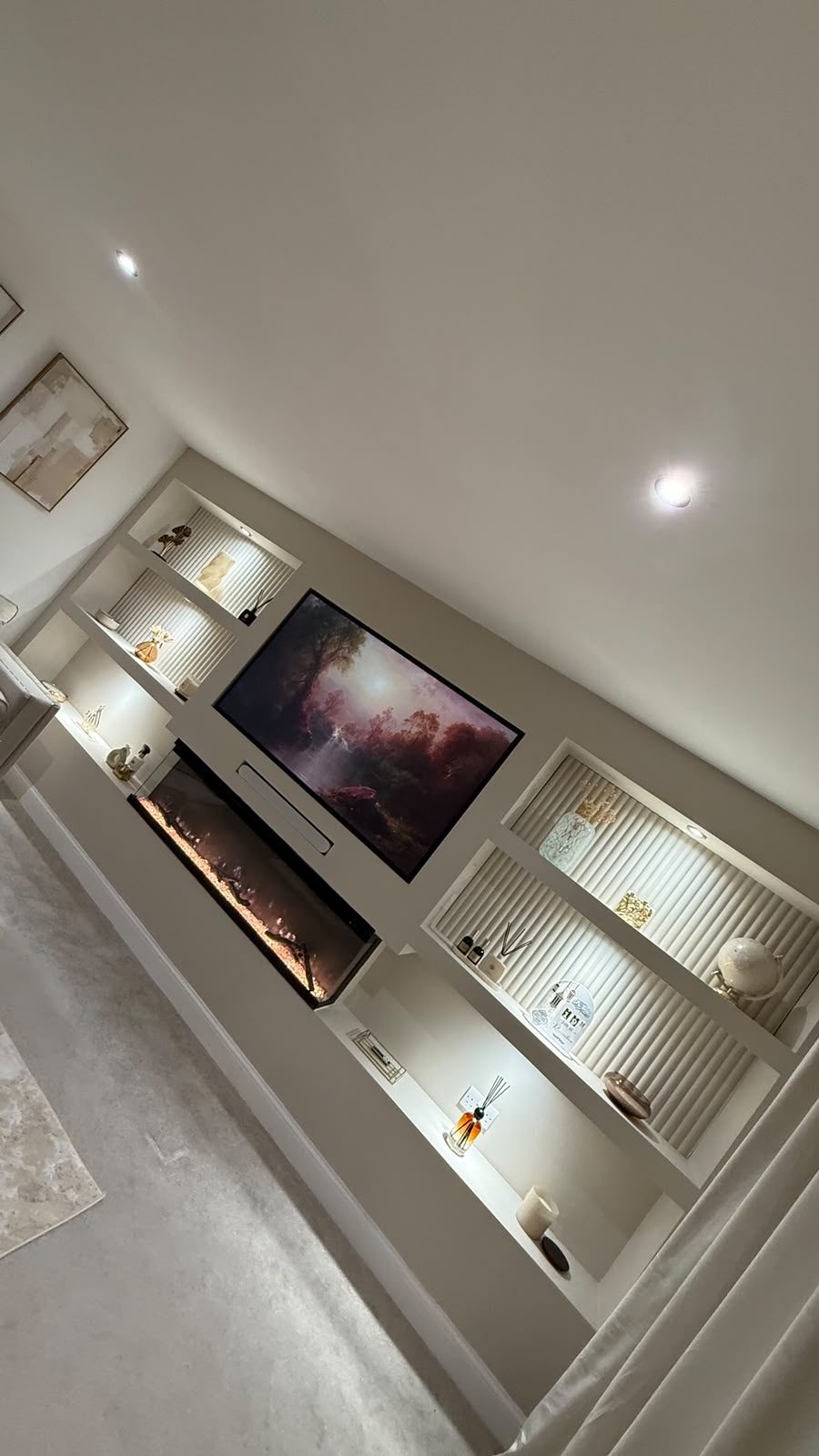 Living room media wall with inset fireplace, finished in soft neutrals
